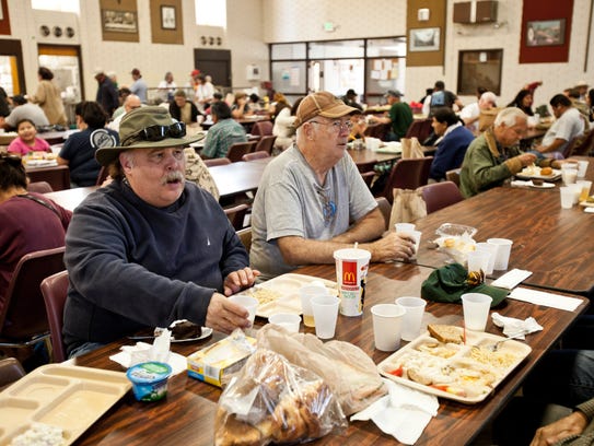 Mark Alward, left, and Larry McDowell eat lunch at St. Anthony's Padua Dining Room in Menlo Park, Calif., on Oct. 29.