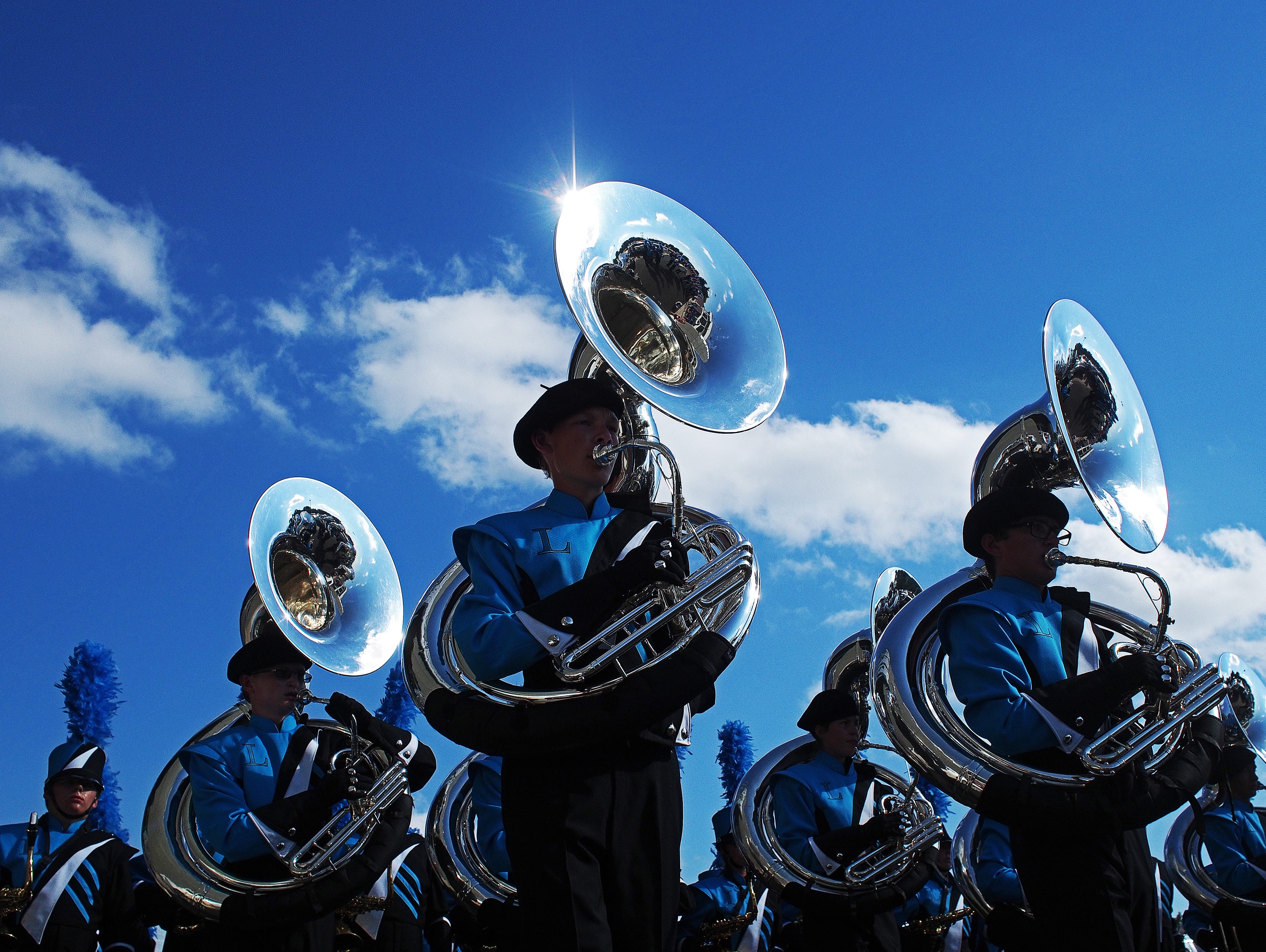 The Lincoln High School marching band performs before a football game between Lincoln and Rapid City Stevens Saturday, Aug. 27, 2016, at Howard Wood Field in Sioux Falls.