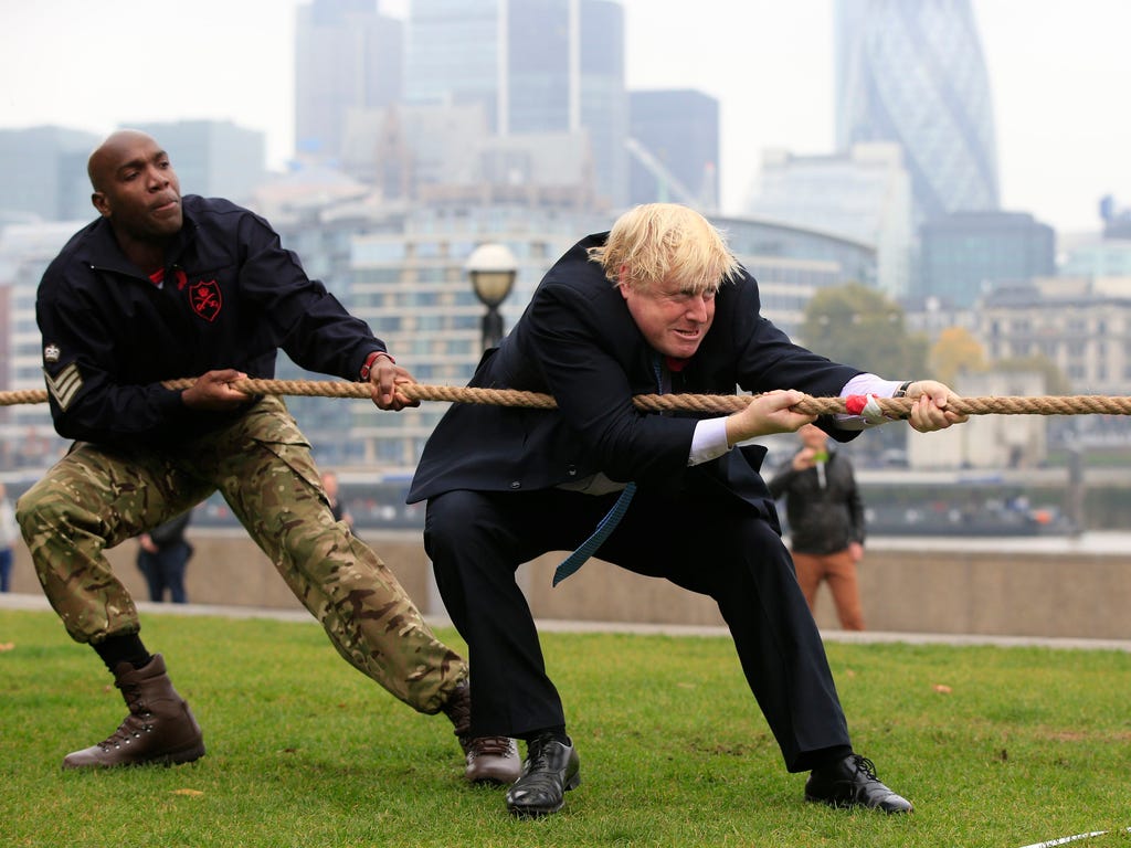 Mayor of London Boris Johnson participates in a tug of war contest with personnel from the Royal Navy, the Army and the Royal Air Force at the launch of London Poppy Day on Potters Field next to City Hall in London.