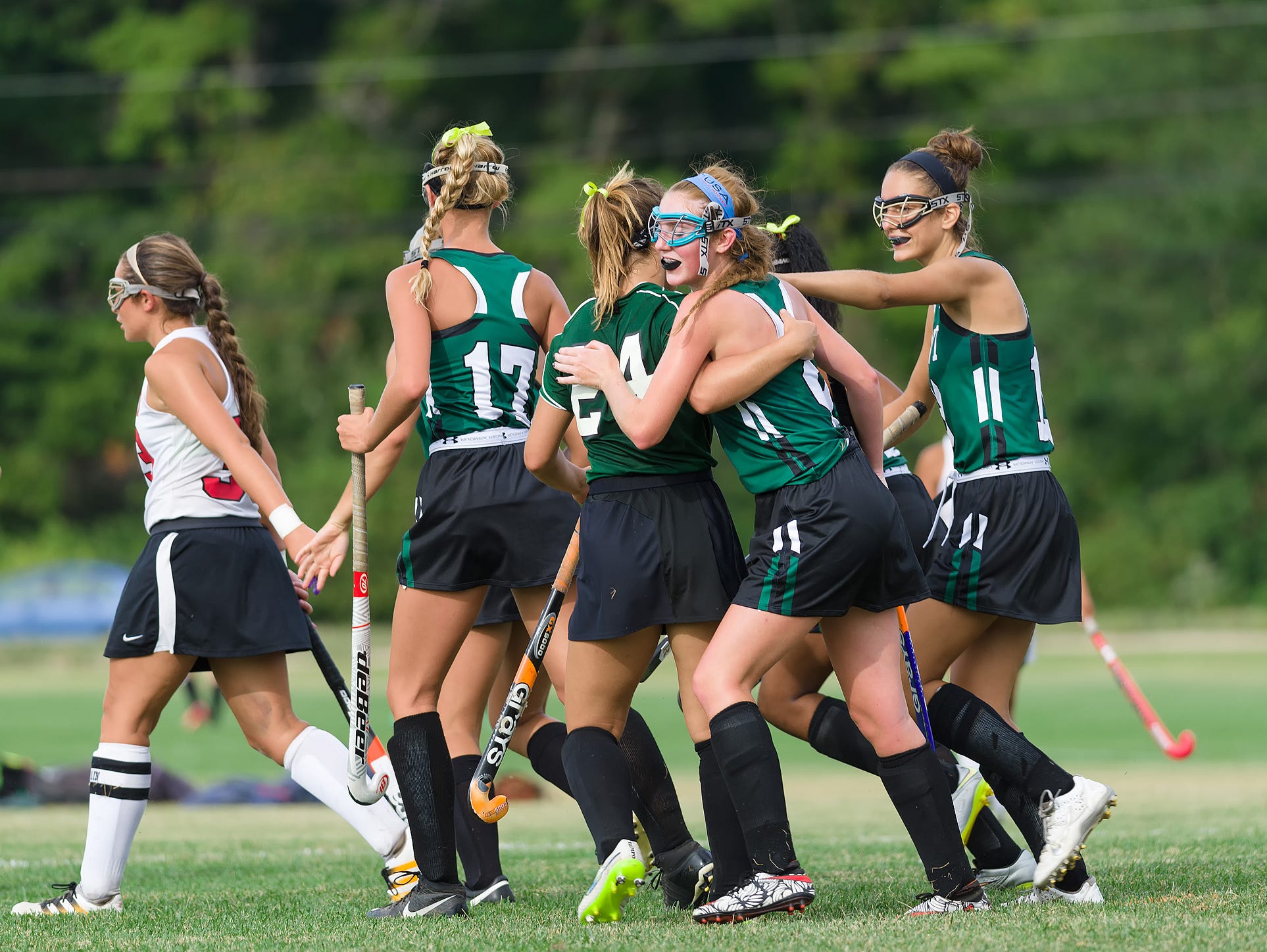 Alexandra Davis (9) of Mt. Pleasant gets congratulated by teammates on her goal in the William Penn vs Mt. Pleasant field hockey game at William Penn on Tuesday.
