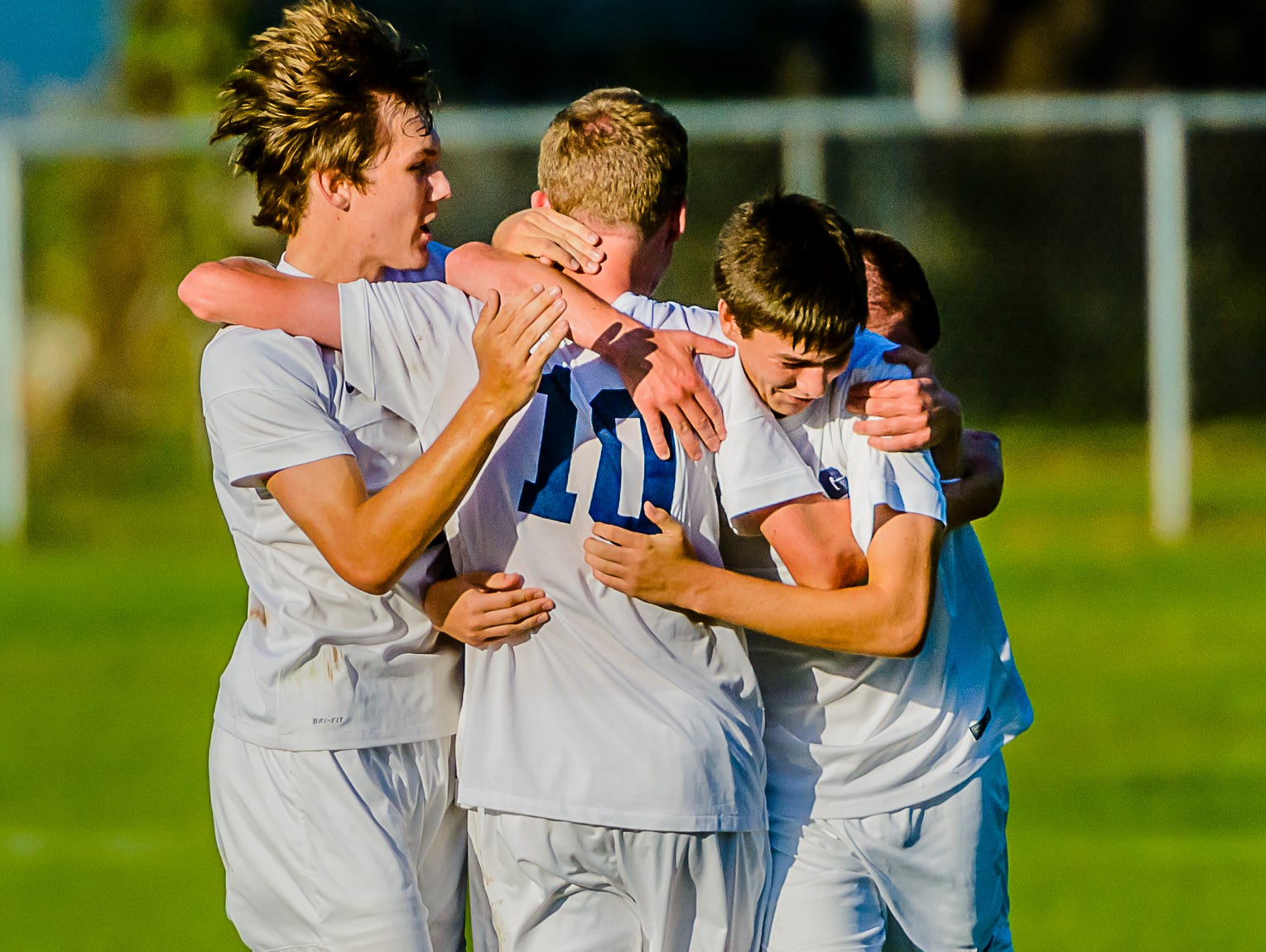 Erik Seelman,10, of Grand Ledge is embraced by some of his teammates after scoring with 10:39 remaining in the 1st half of their CAAC Gold Cup first round game with Jackson Tuesday October 4, 2016 in Grand Ledge. The goal put Grand Ledge up 1-0 and proved to be the game winner.