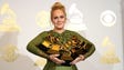 Adele poses with her five Grammy awards.in the photo