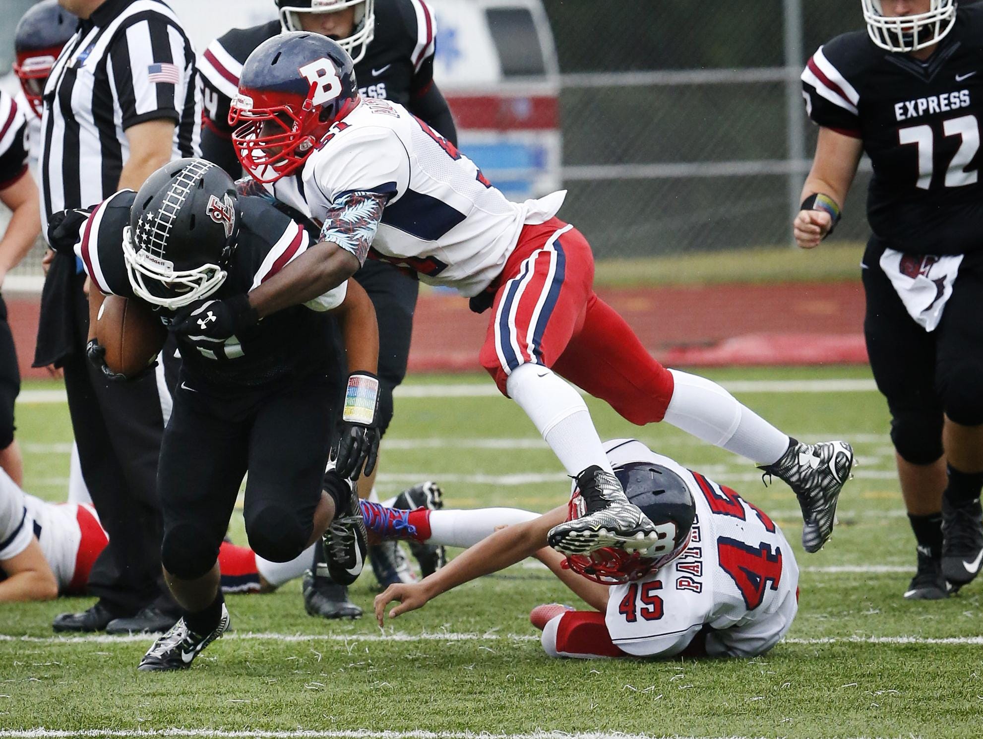 Elmira Express running back Dashaun Sutton attempts to deflect a blow by a Binghamton Patriot.