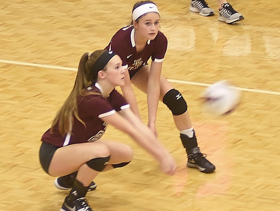 Kendall Key goes down to return the ball Thursday night as Savannah Jones looks on.