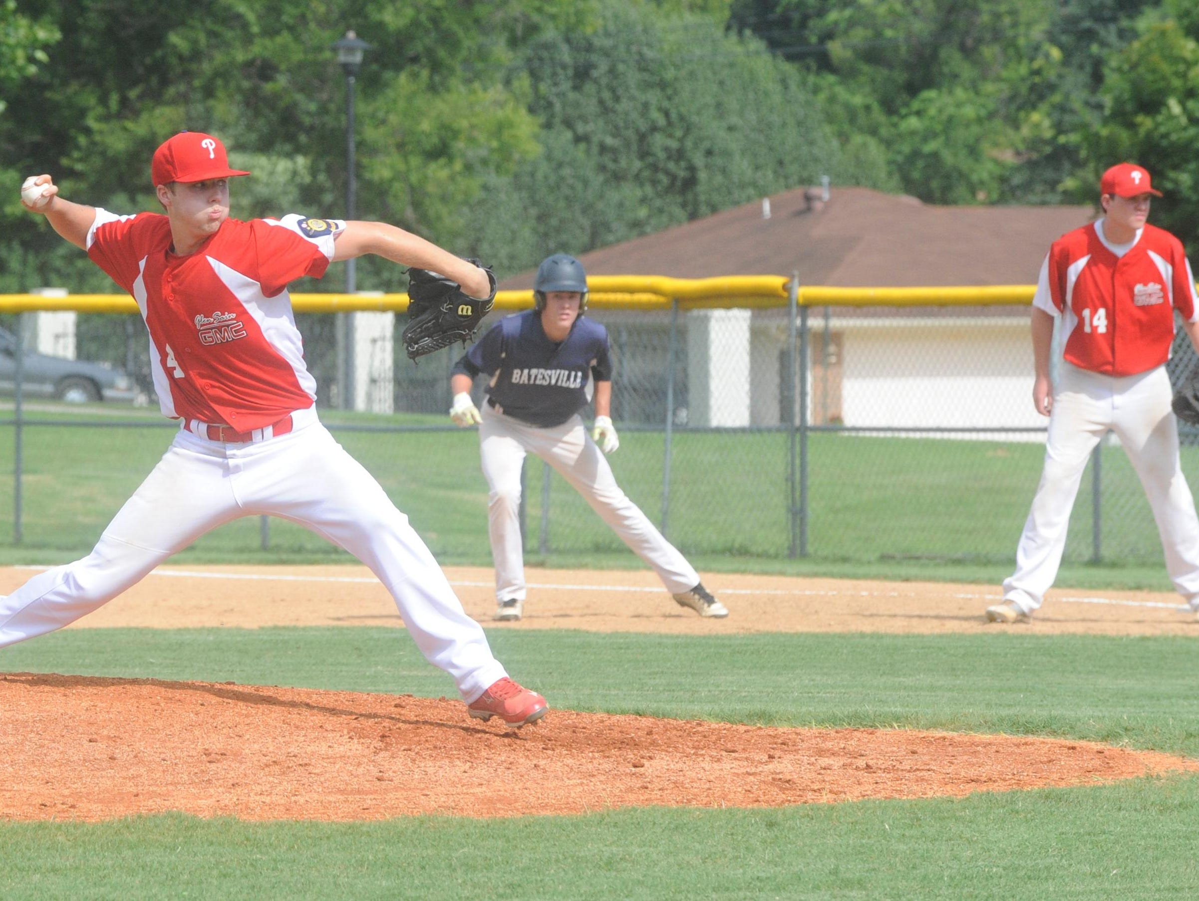 Paragould pitcher Trace Huckabay, left, delivers a pitch while Batesville’s Jesse Sampley leads away from first base during Glen Sain GMC’s 15-5 victory over the Highwaymen in the first round of the Zone 2 American Legion District Tournament on Friday at Cooper Park.