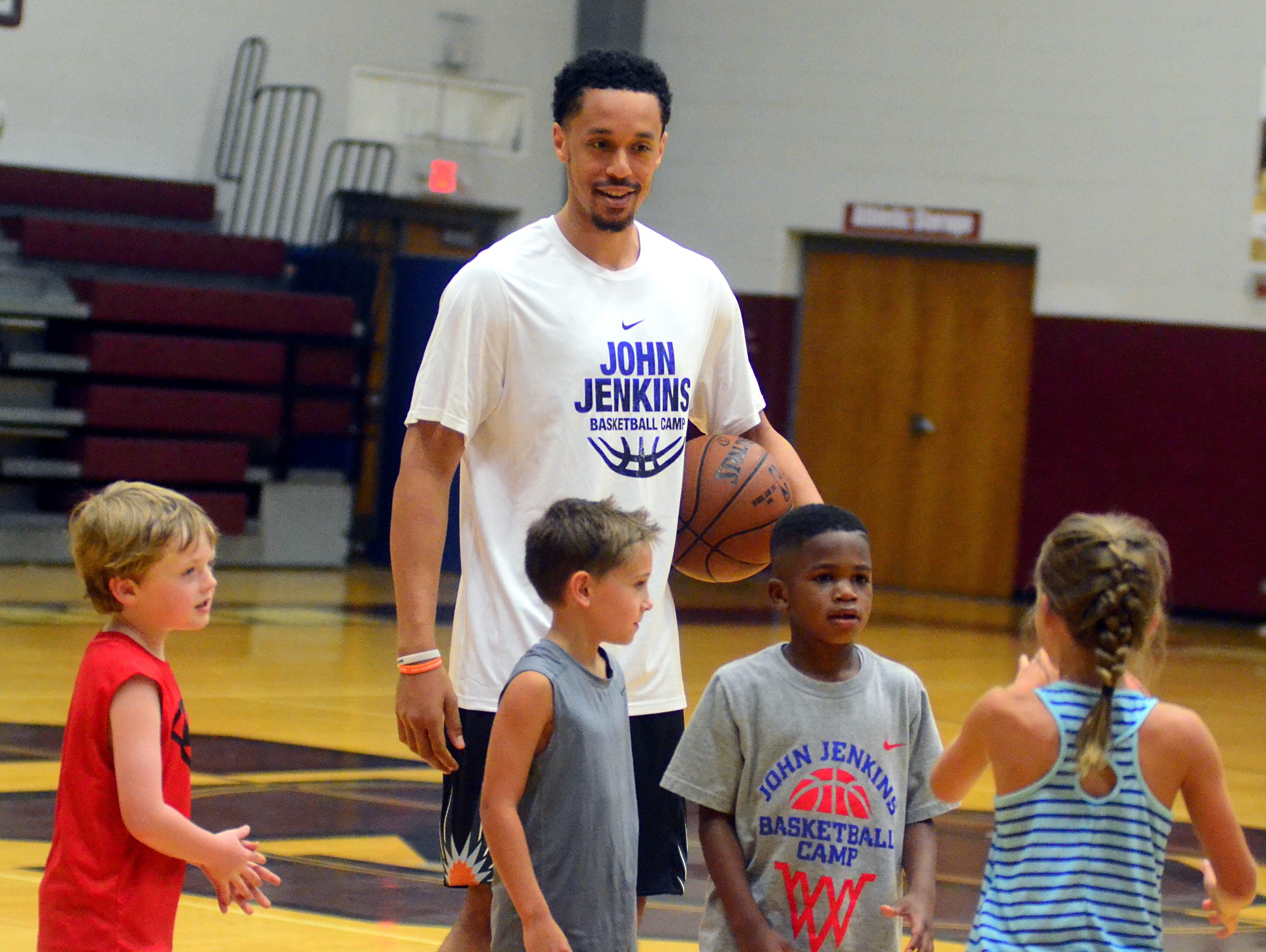 Phoenix Suns guard John Jenkins works with some younger players during the final day of his fourth annual basketball camp at Station Camp High School.