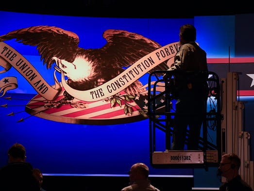 Crews work on the stage in preparation for the third