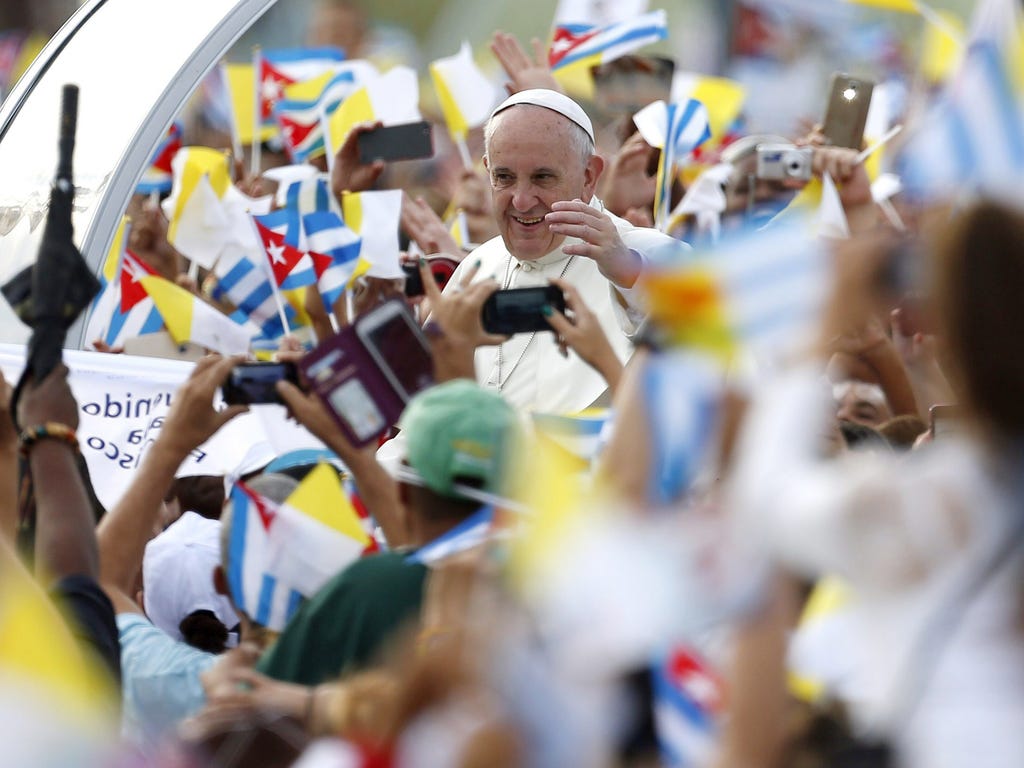 Pope Francis waves from the popemobile upon his arrival to the Revolution Plaza to celebrate a Sunday Mass in Havana.