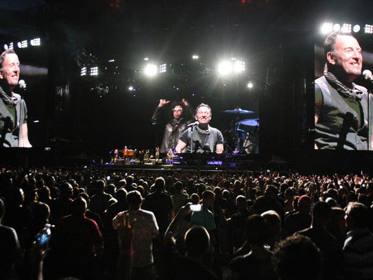 Bruce Springsteen towers over the audience as he performs