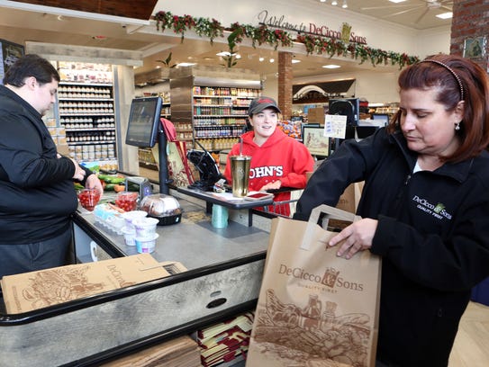 Elizabeth Salvatore bags groceries for Nicole Mahig,