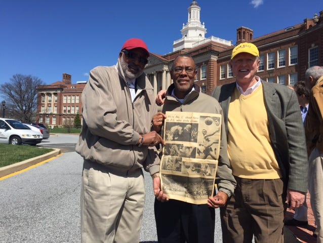 P.S. du Pont 1968 state championship basketball team members (L-R) Ronnie Smith, Clinton Tynes and Randy Johnson with a Morning News picture page from their state-title win. On the other side was a Ku Klux Klan ad.