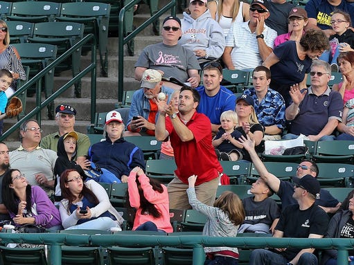 Some fans at Frontier Field protect themselves as others