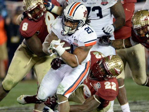 Florida State Seminoles linebacker Telvin Smith (22) tackles Auburn Tigers running back Tre Mason (21) during the second half of the 2014 BCS National Championship game at the Rose Bowl.