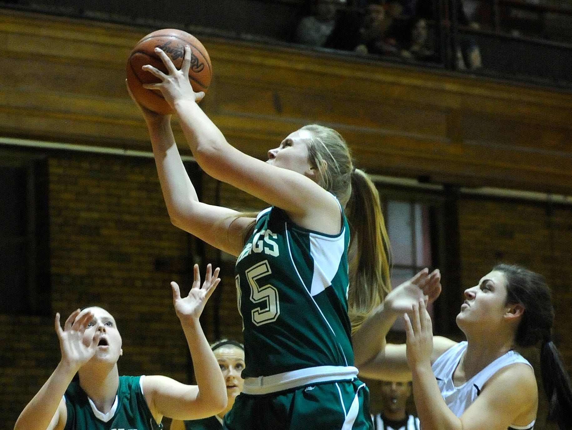 North ridge's Hallie Martin (center) pulls down a rebound over teammate Kendra Martin and Granville Christian's Leag Benvie. The Lions defeated the Vikings 38-27 on Friday, Nov. 20, 2015, at the Fifth Street Gym in Newark.