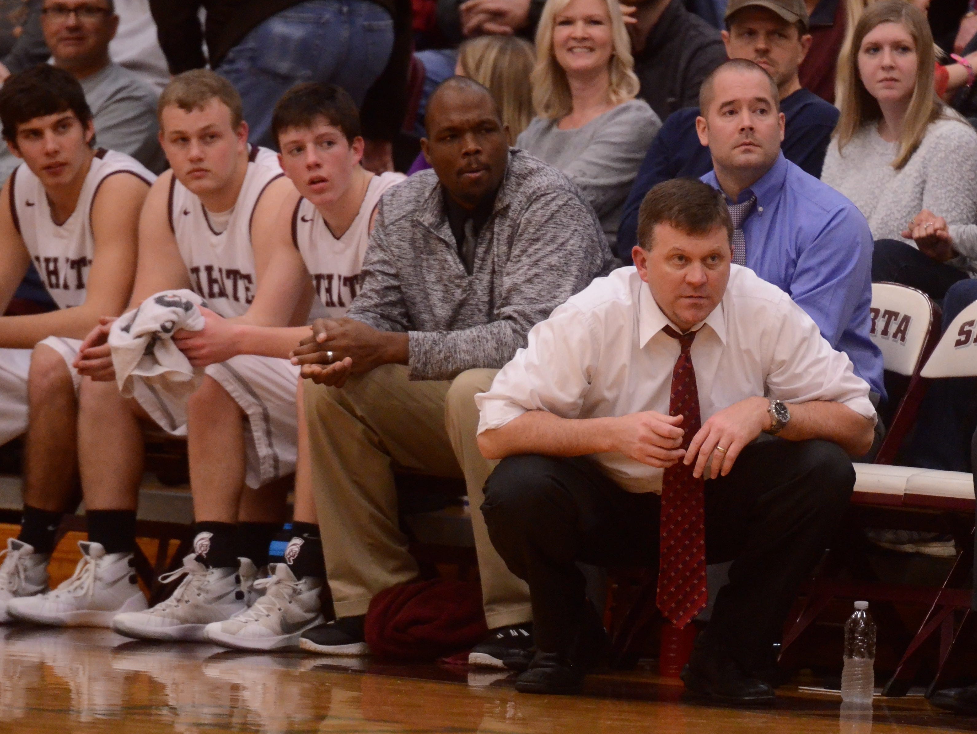 White County coach Eric Mitchell (right) looks on during Monday's regular-season finale.