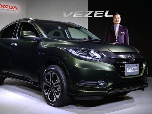 Takanobu Ito, president of Japan's auto maker Honda Motor, unveils the new vehicle Vezel' during a press conference in Tokyo