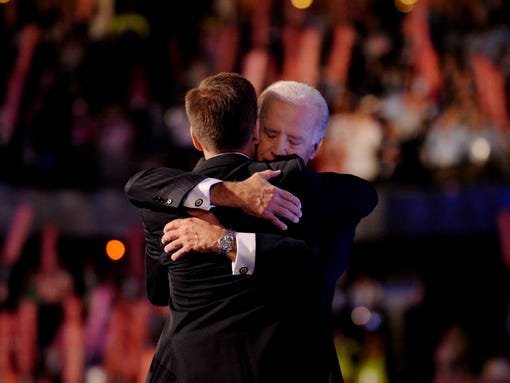 Vice presidential candidate Joe Biden hugs his son