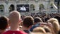 People watch Pope Francis address a joint session of