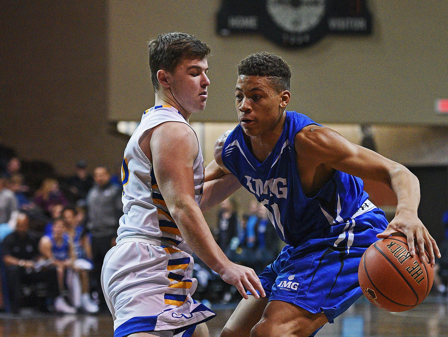 IMG Academy's Keyontae Johnson (11) tries to get past O'Gorman's Riley Katen (10) during the Gary Munsen Tournament Championship game Friday, Dec. 30, 2016, at the Sanford Pentagon in Sioux Falls.