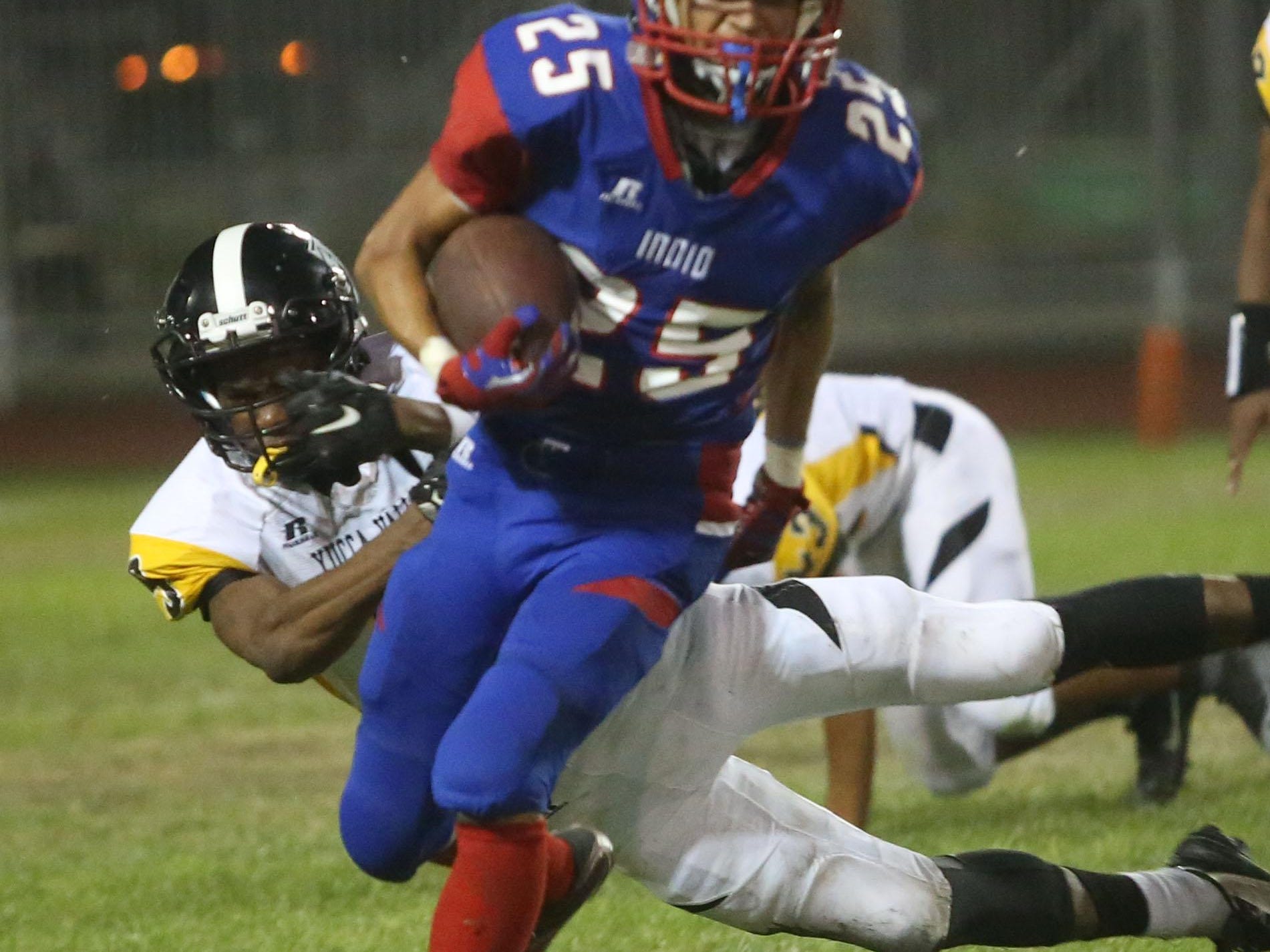 Indio High School's Joseph Gonzalez runs for yardage against Yucca Valley during their game at Ed White stadium in Indio on Friday. Indio won 29-6.