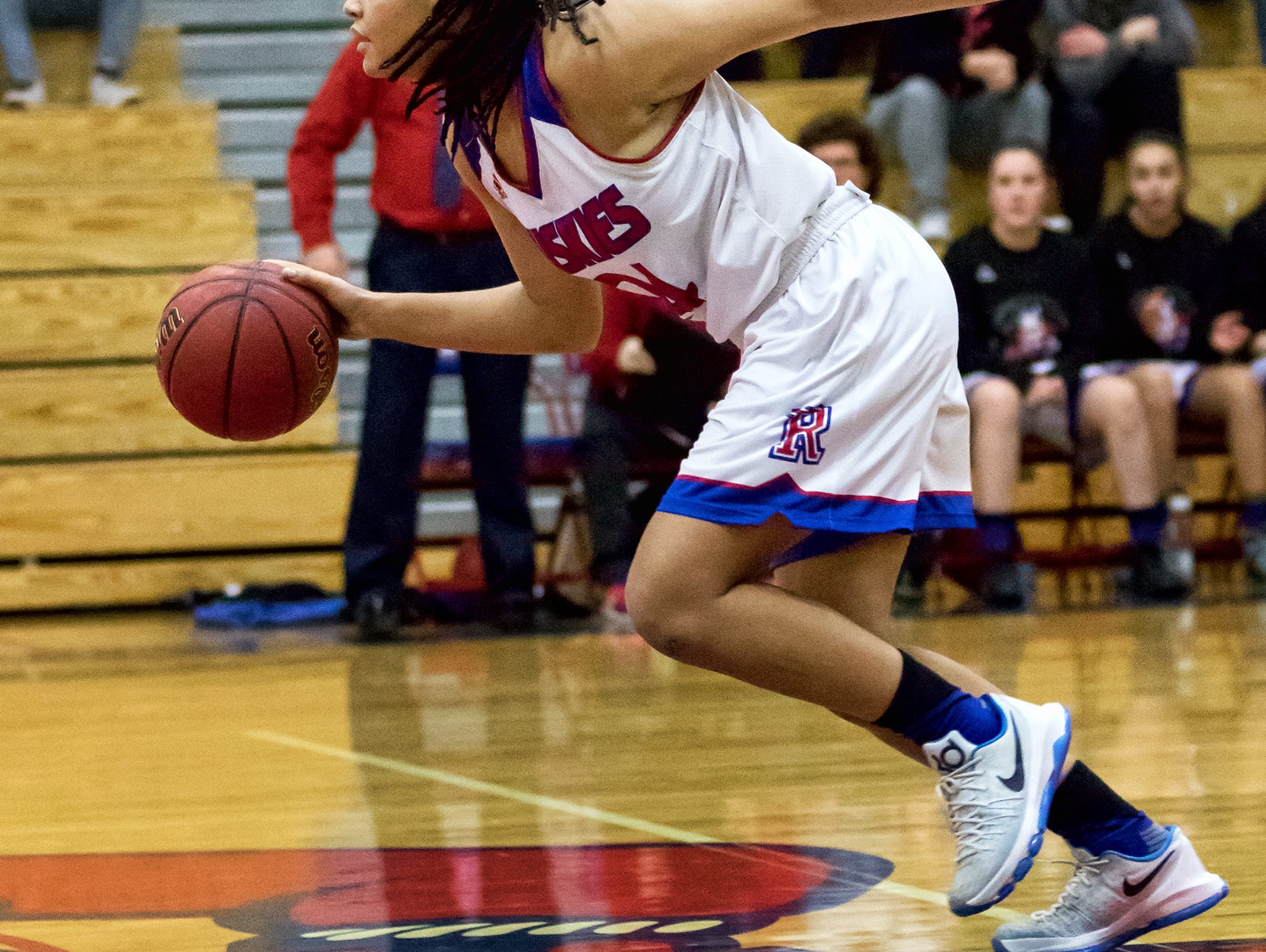 Reno's Kaitlynn Biassou dribbles against Reed on Friday.