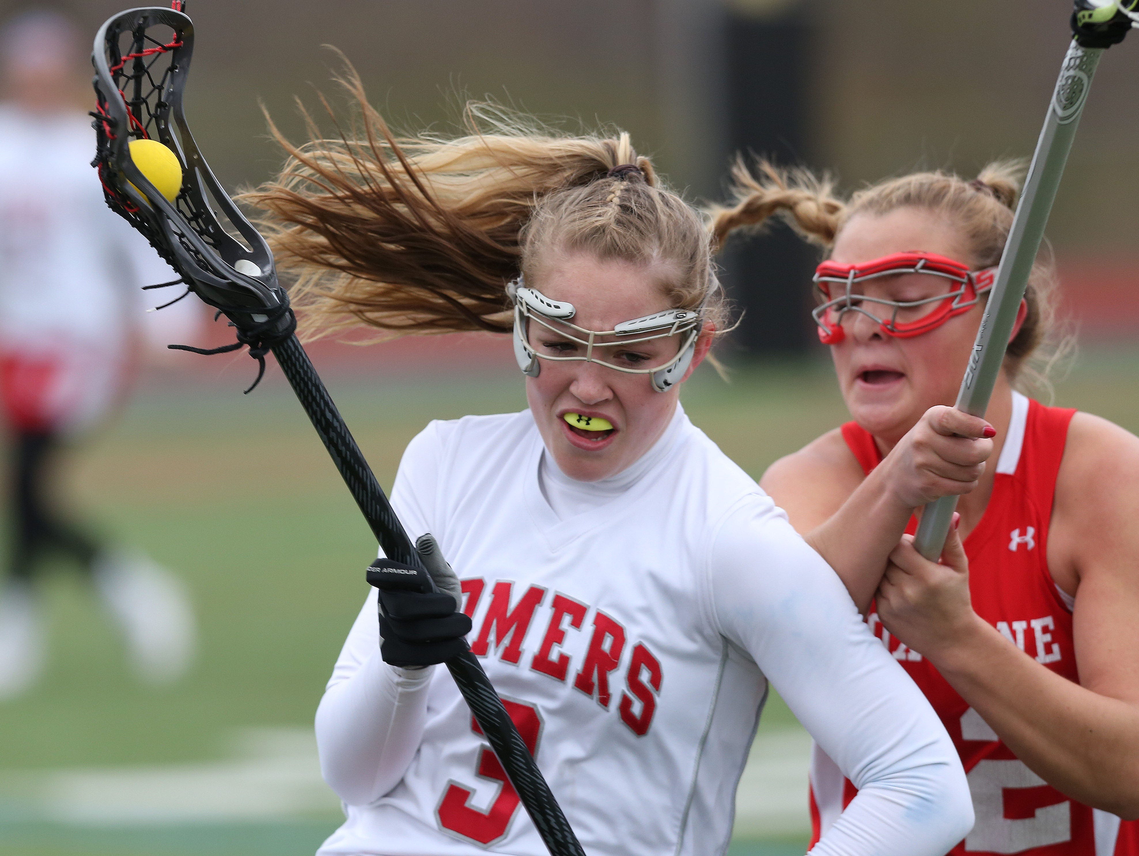 Somers' Gabby Rosenzweig (3) tries to get around Fox Lane's Lindsey West (12) during a girls lacrosse game at Somers High School April 8, 2016. Somers won the game 15-12.