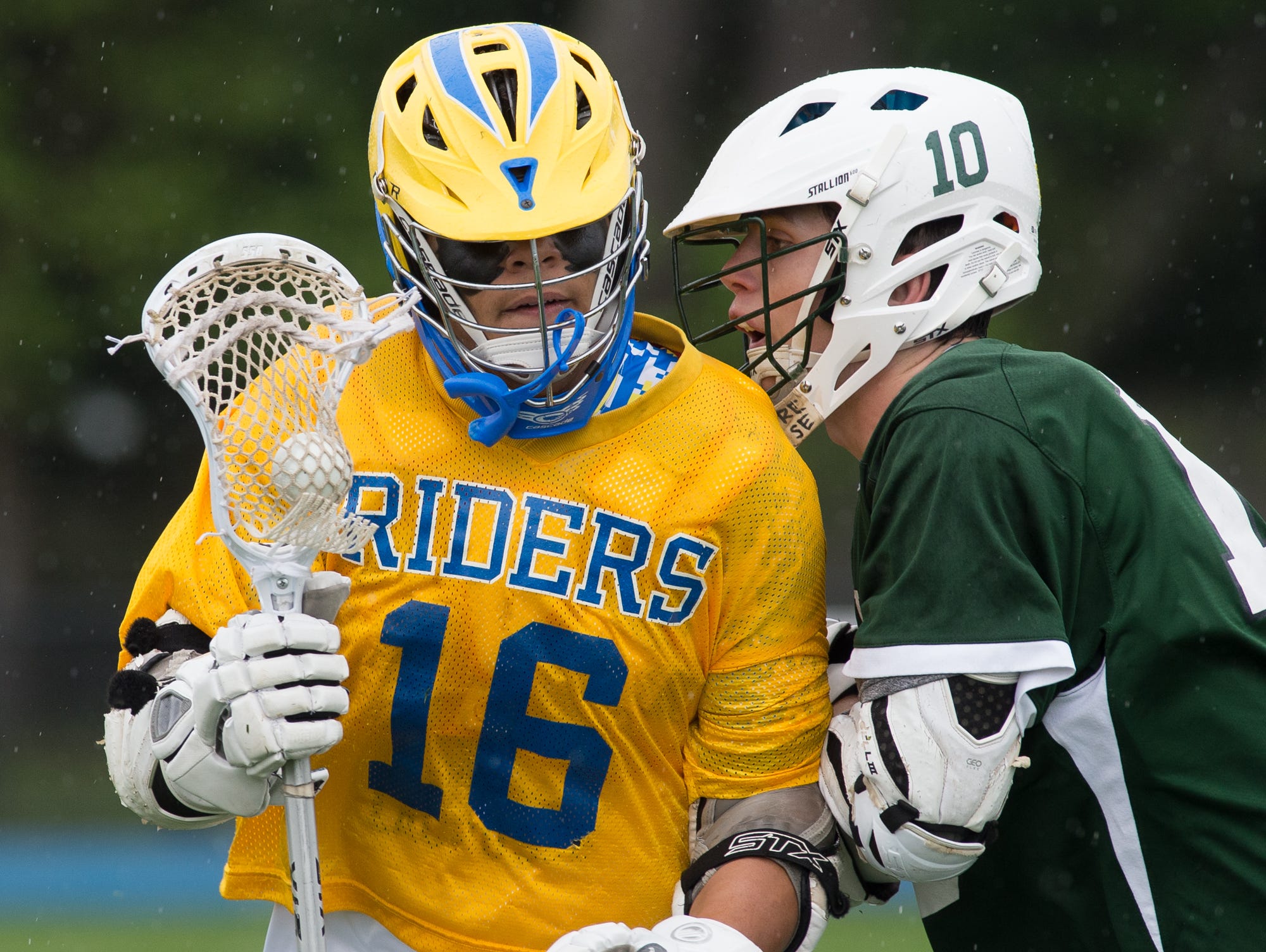 Caesar Rodney's Demetrius Stevenson (16), left runs with the ball as Tower Hill's James Spruance (10) tries to block him.