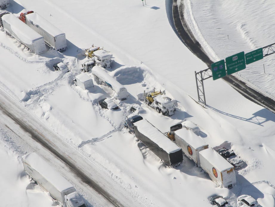 Trucks and cars are stranded on the freeway.