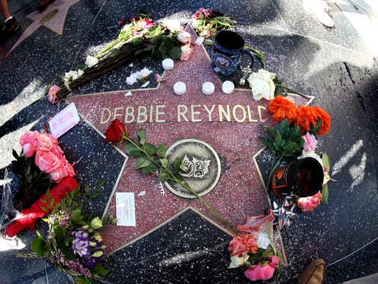 Mementos are placed on the star of the late actress