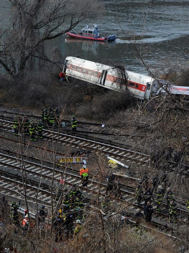 First responders work the scene of the Metro North train derailment near Spuyten Duyvil Station, Bronx, N.Y.
