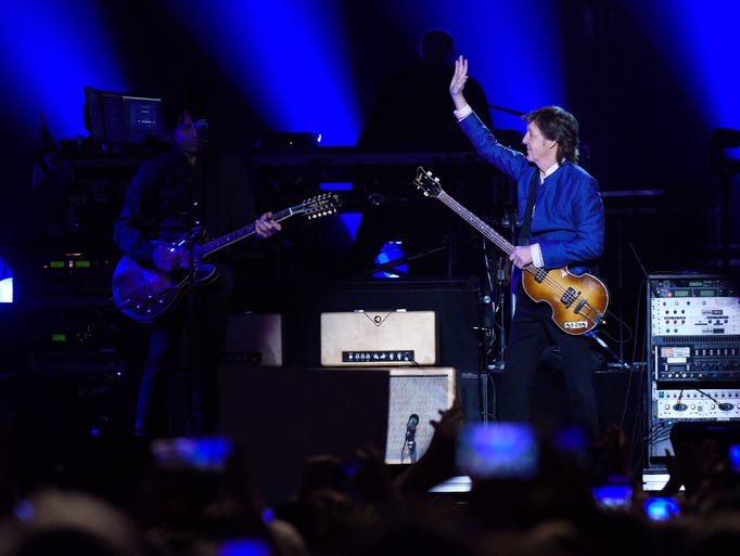 Paul McCartney waves to the audience before performing