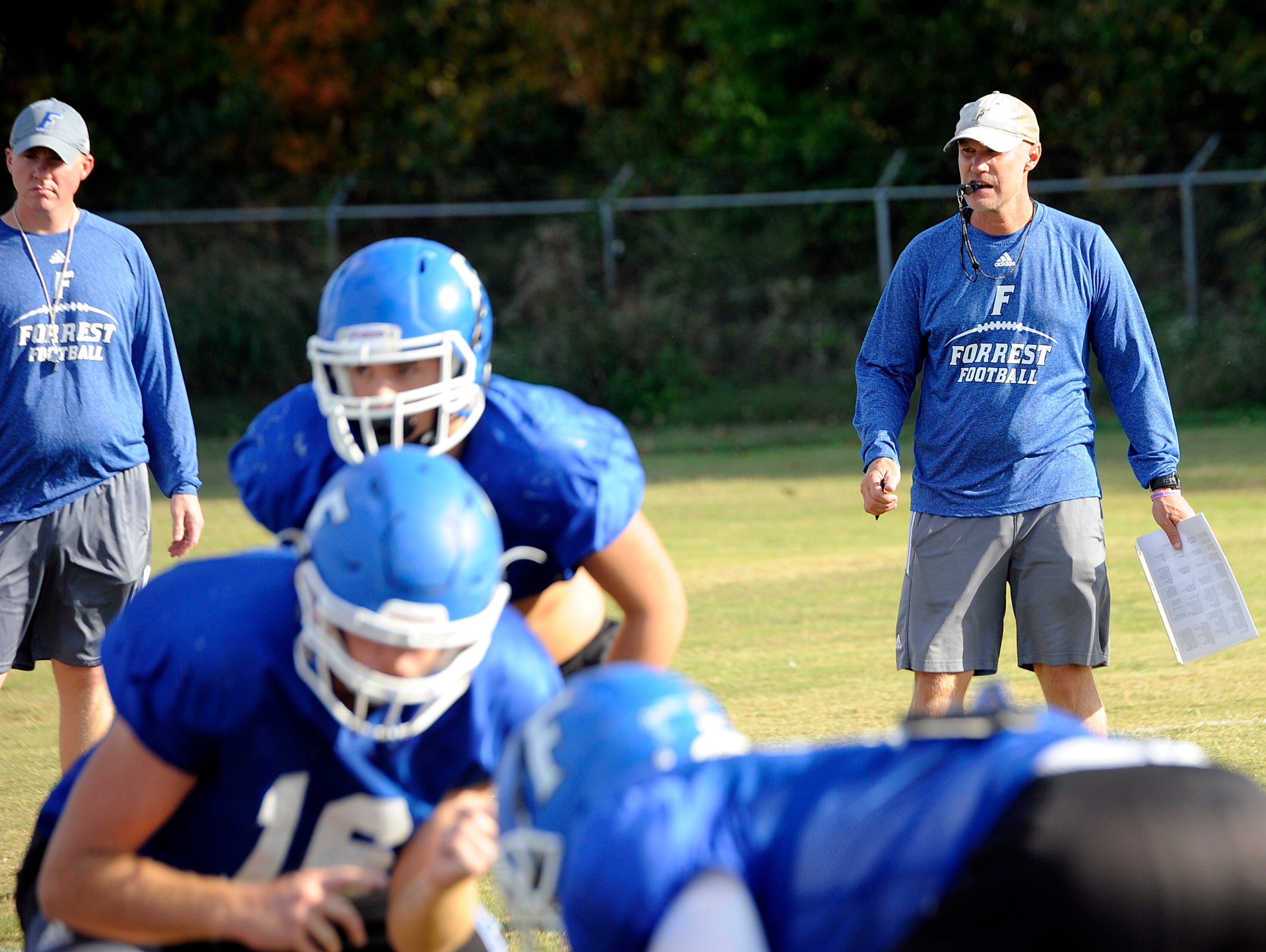 Forrest head coach Brent Johns (at right) looks on during Monday's practice.