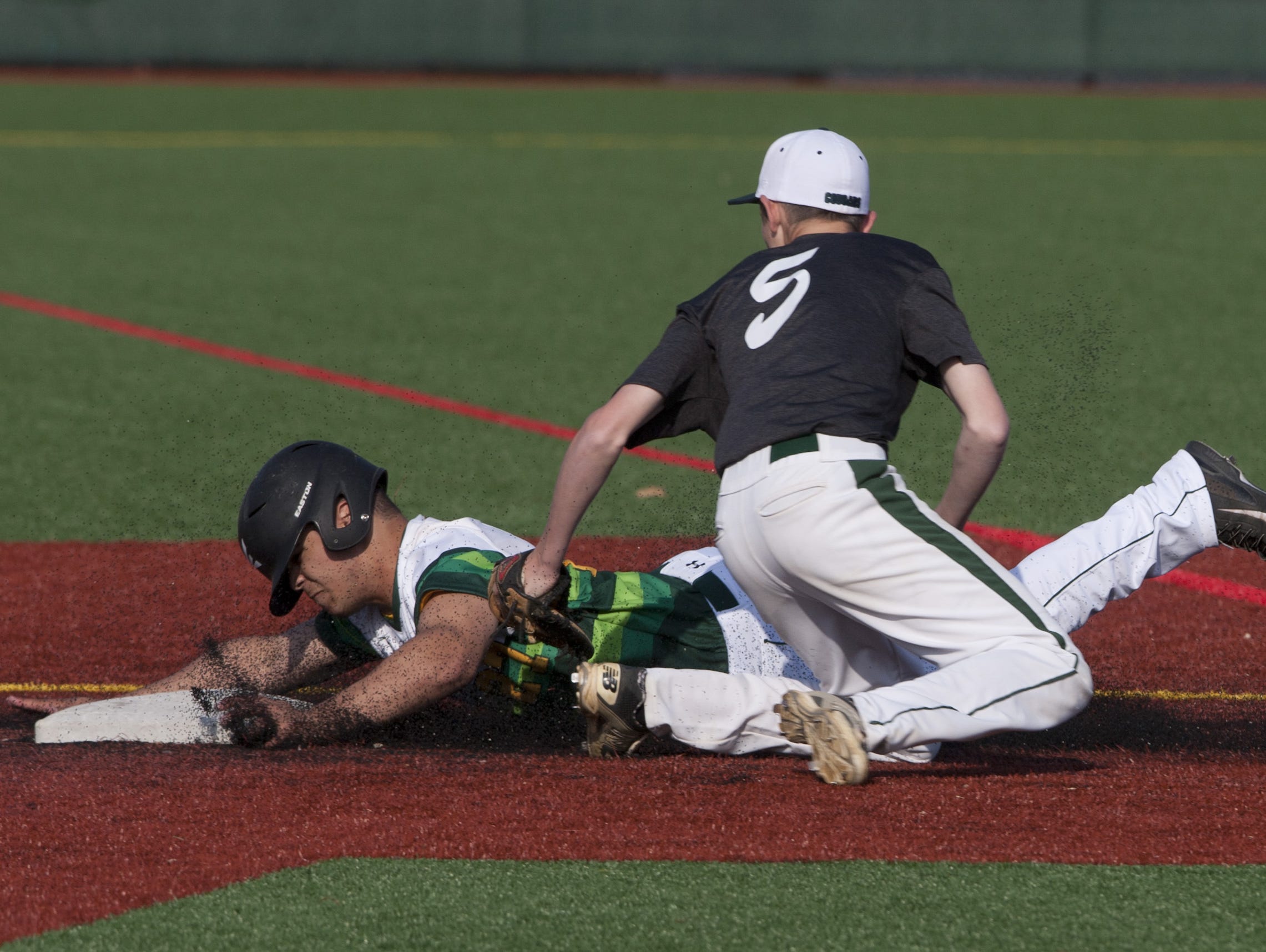 Colts Neck's Tim Cavrak puts the tag on Red Bank Catholic's Dom Caraballo trying to steal second in the fourth inning.
