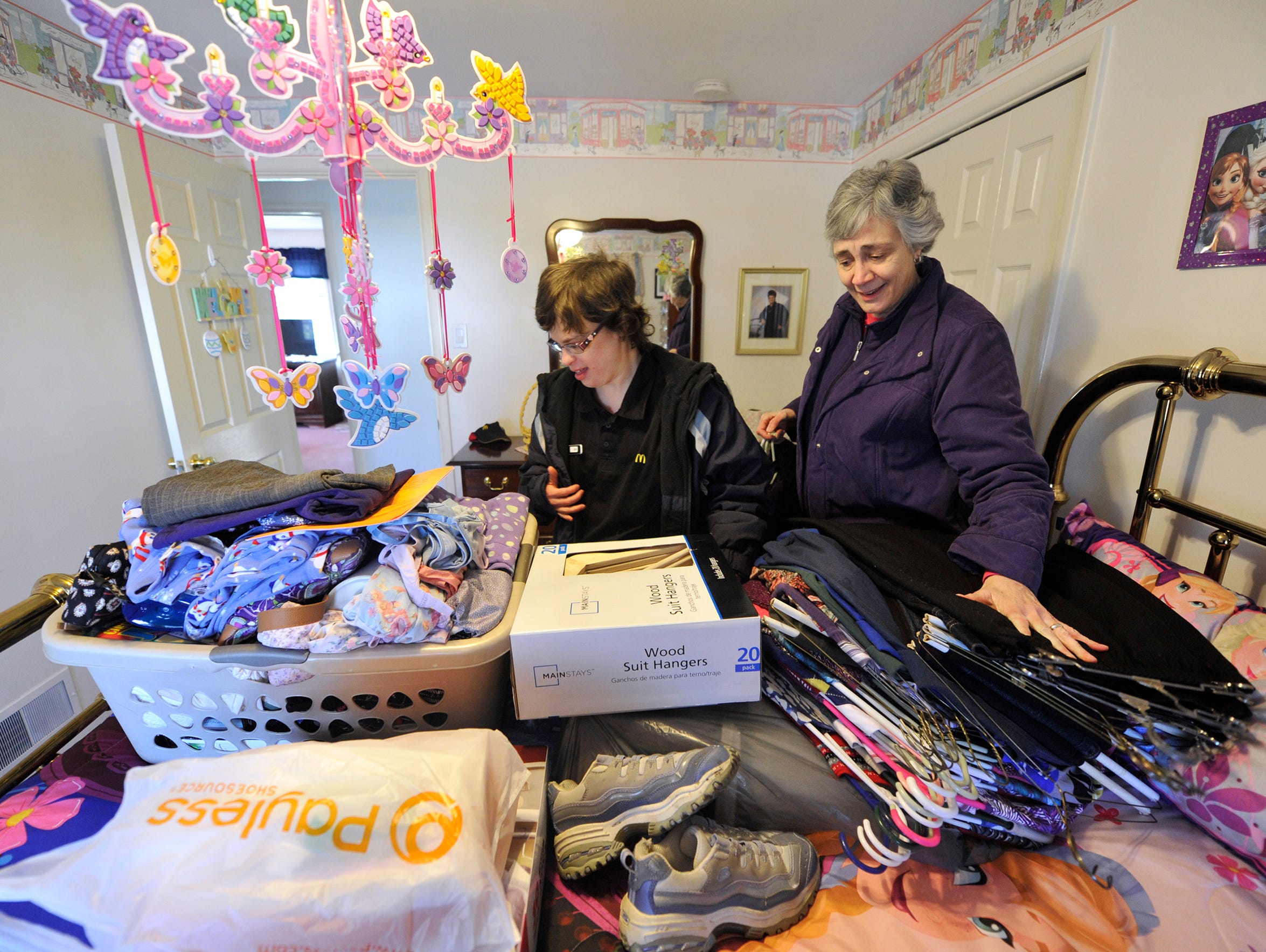 Suzanne Keim, right, helps her daughter, Sarah Keeney,
