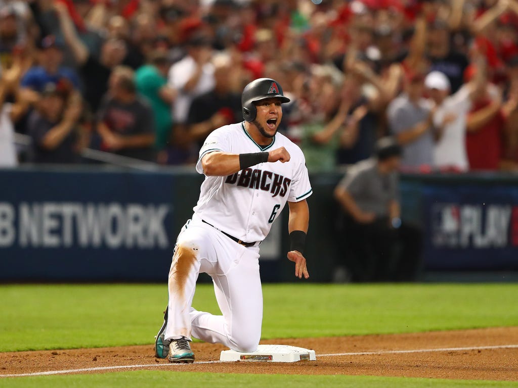 Arizona Diamondbacks right fielder David Peralta reacts after reaching third base during the first inning in the 2017 National League wildcard playoff baseball game against the Colorado Rockies at Chase Field in Phoenix.