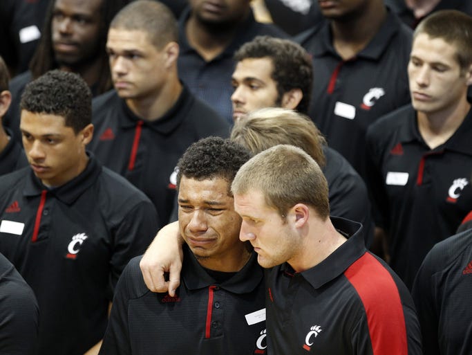Members of the University of Cincinnati football team mourn during a memorial service for Ben Flick, 19, who died in a car crash in Hanover Twp. The memorial service was held September 24, 2013 at Hamilton High where Flick was a standout on the football team.