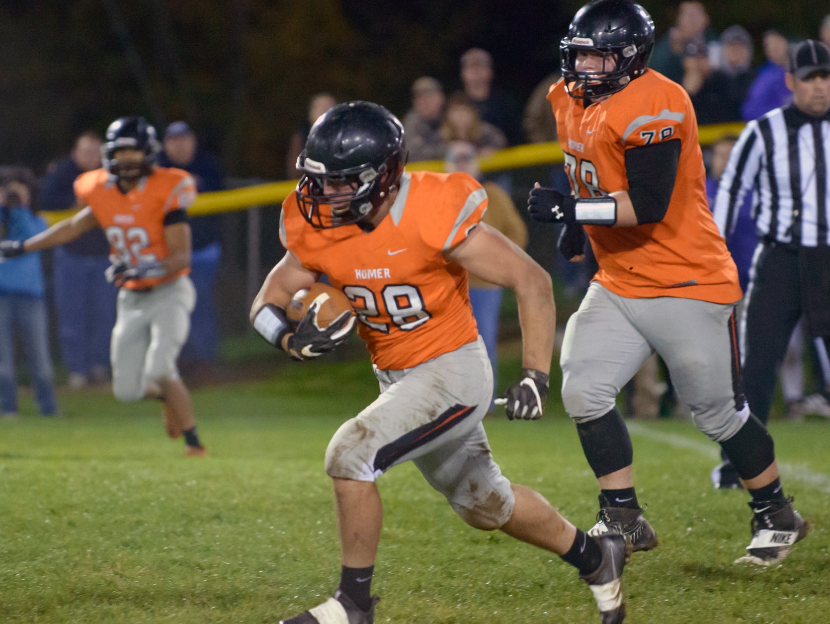 Homer RB Hunter Wilson (28) rushes for positive yards Friday night.