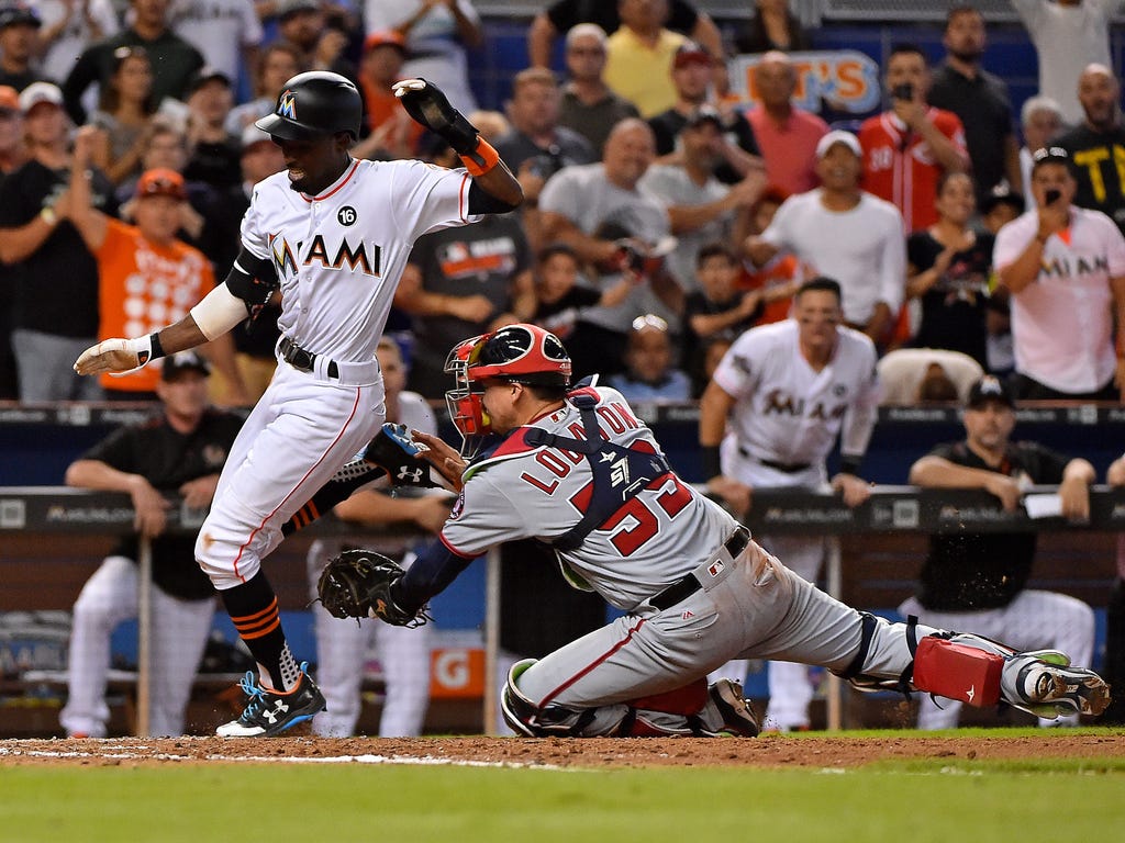 Marlins second baseman Dee Gordon is tagged out at home by Nationals catcher Jose Lobaton in the eighth inning at Marlins Park in Miami.