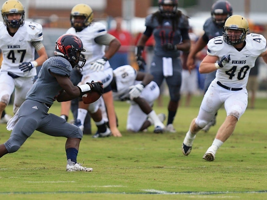 Wakulla's Justin Davis tries to evade Spartanburg tacklers during Saturday's game, which was shown on ESPN U.