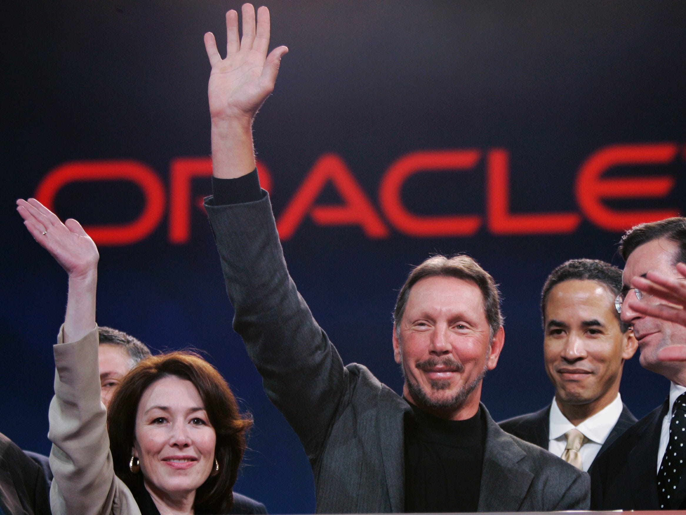 Larry Ellison, center, smiles with Oracle  CFO Safra Catz (now also president), left, during the Oracle Open World conference on  Oct. 25, 2006, in San Francisco.