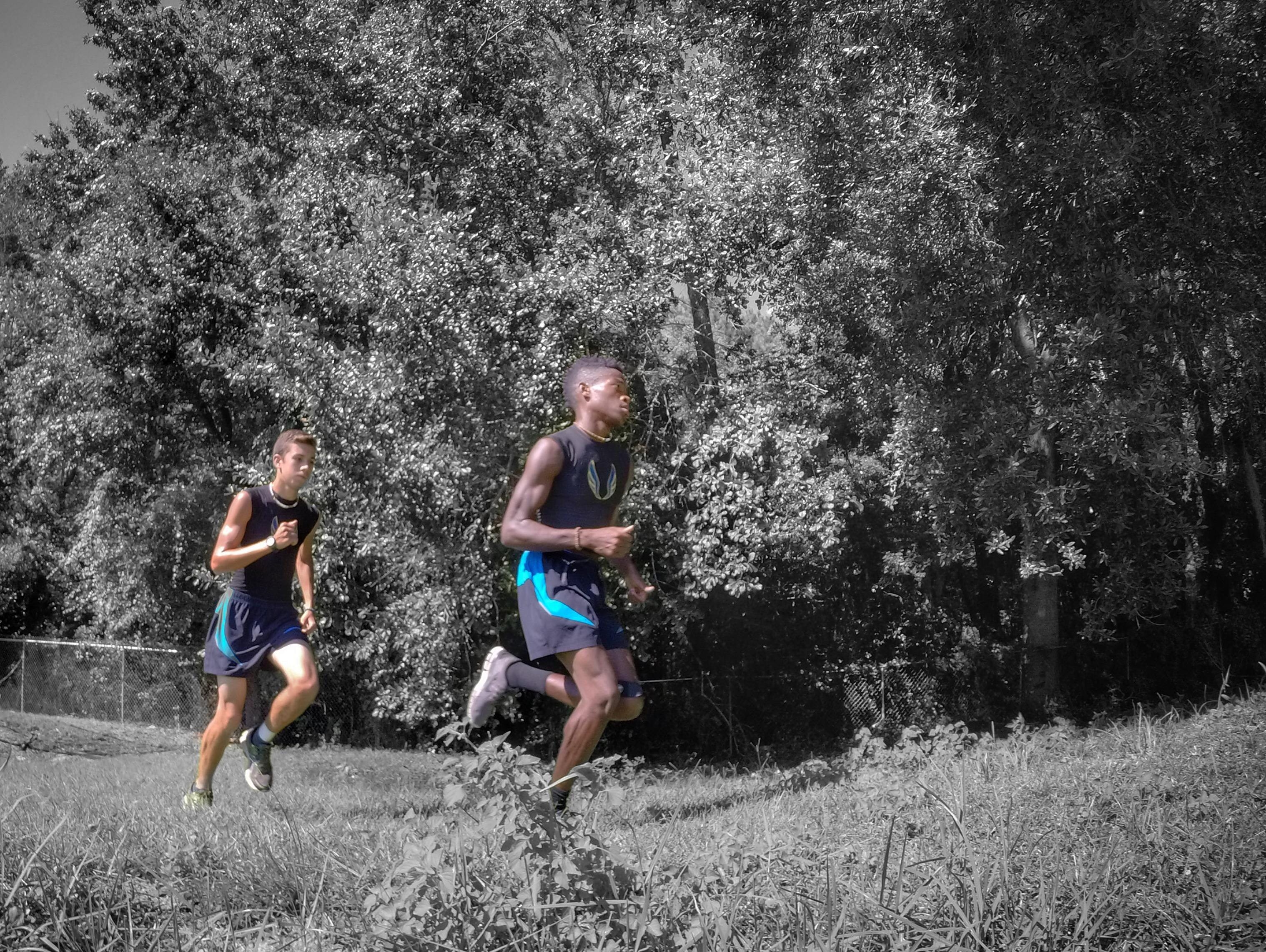 Rickards seniors Evan Garrison and Solomon Stevens go for a 3-mile warm-up run on campus to start Monday’s cross country practice.