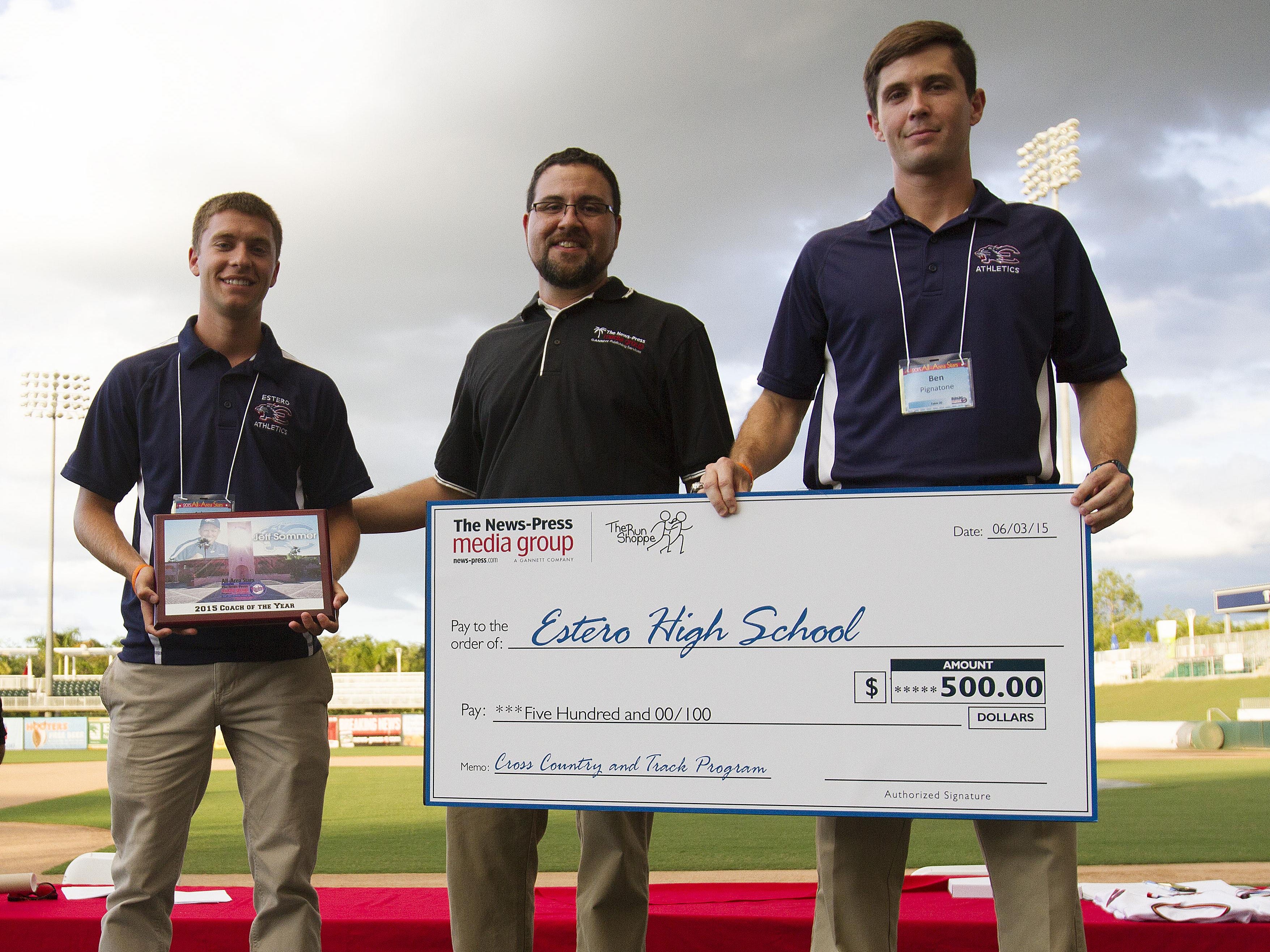 Adam Sommer, left, the son of the late Jeff Sommer and Ben Pingatone, right, the assistant track and field coach at Estero High School accept a five hundred dollar check from the News-Press Media Group in honor of the Coach Sommer. Handing out the donation is News-Press content coach, Ed Reed.