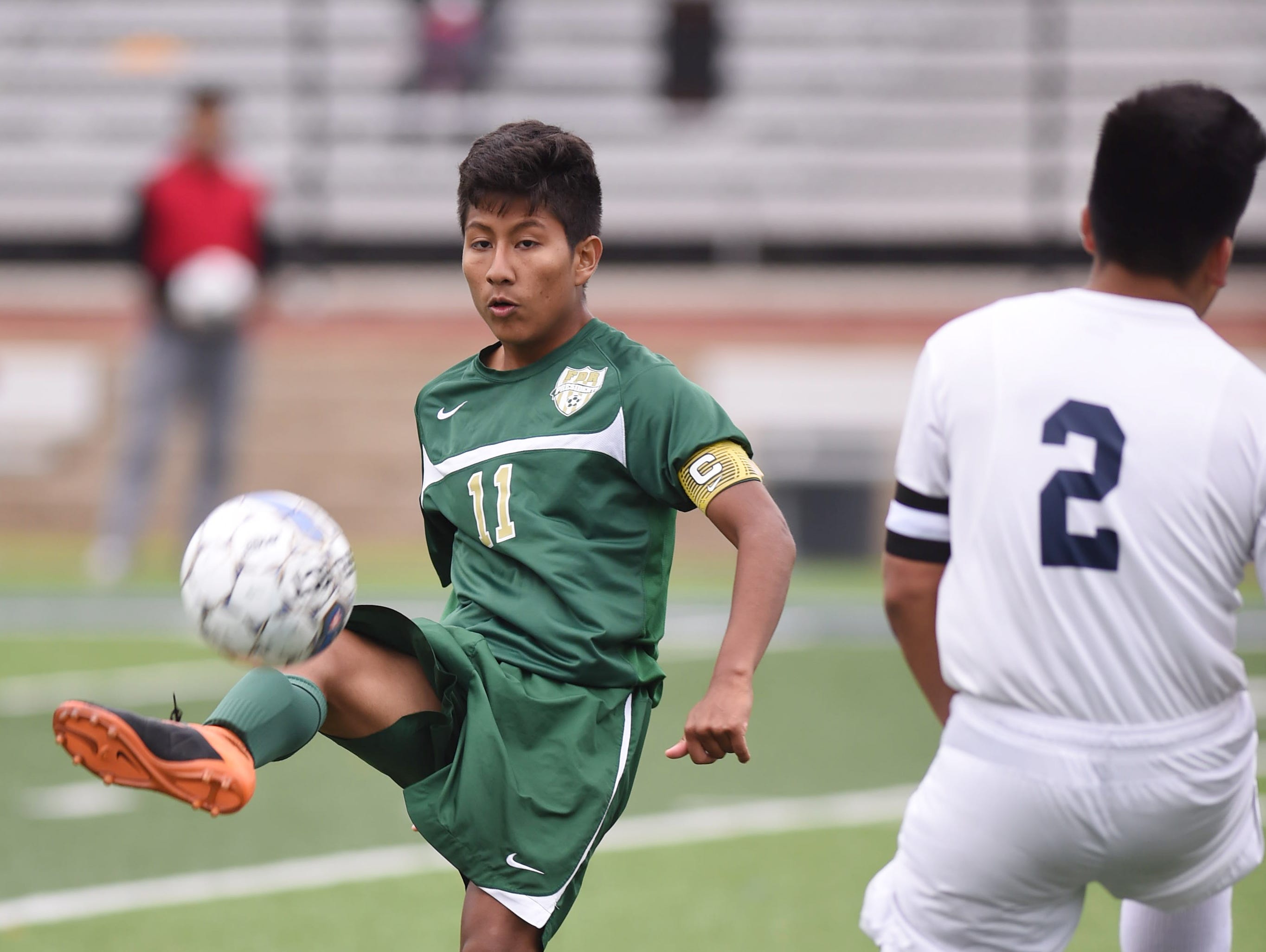 FDR's Jair Cruz traps the ball while Poughkeepsie's Daniel Juarez covers him during Thursday's game in Poughkeepsie.