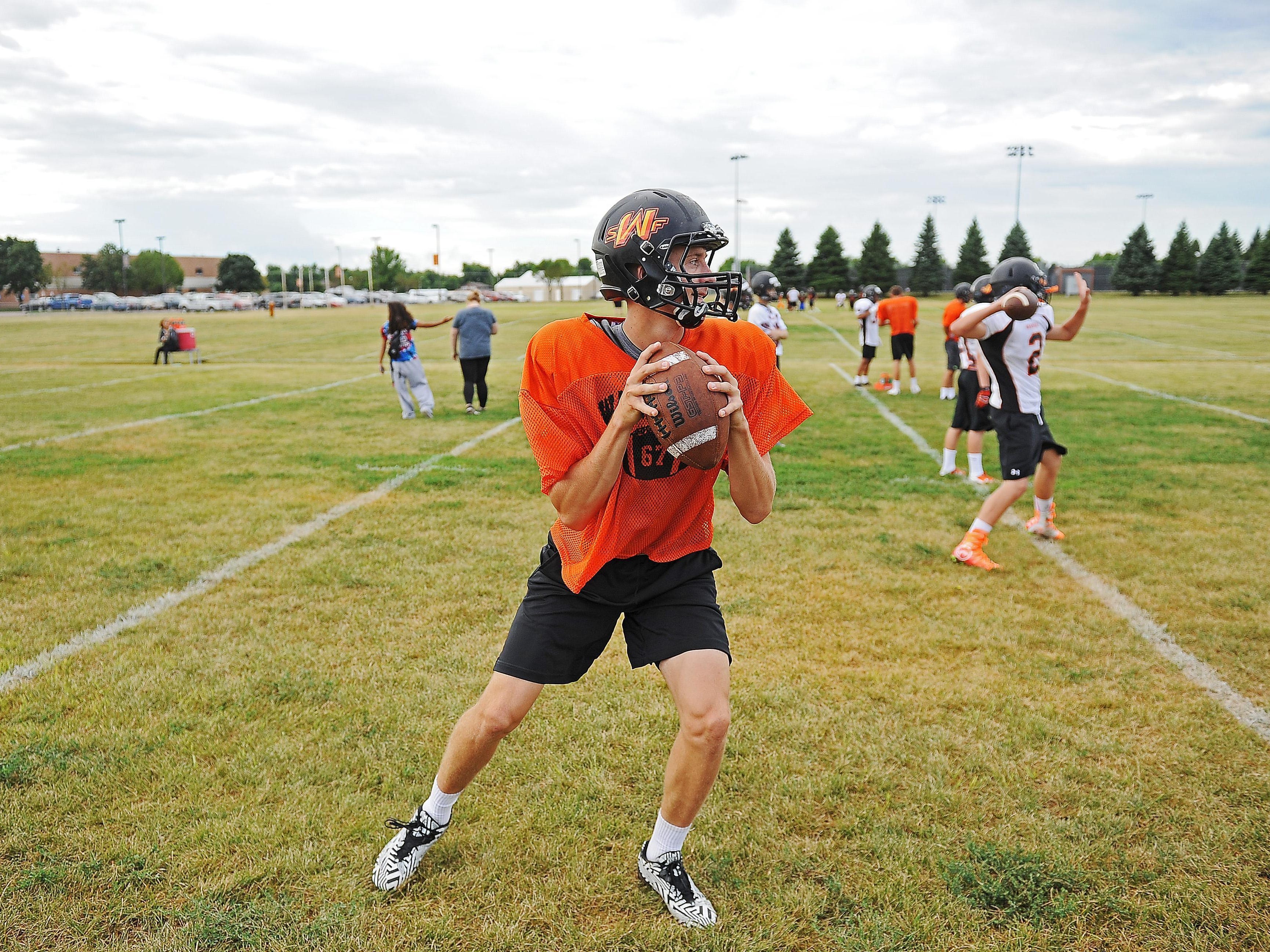 Washington quarterback Jayden Johannsen (67) winds up for a pass while taking part in a drill during a Washington High School Football Practice Thursday, Aug. 11, 2016, at Washington High School in Sioux Falls.