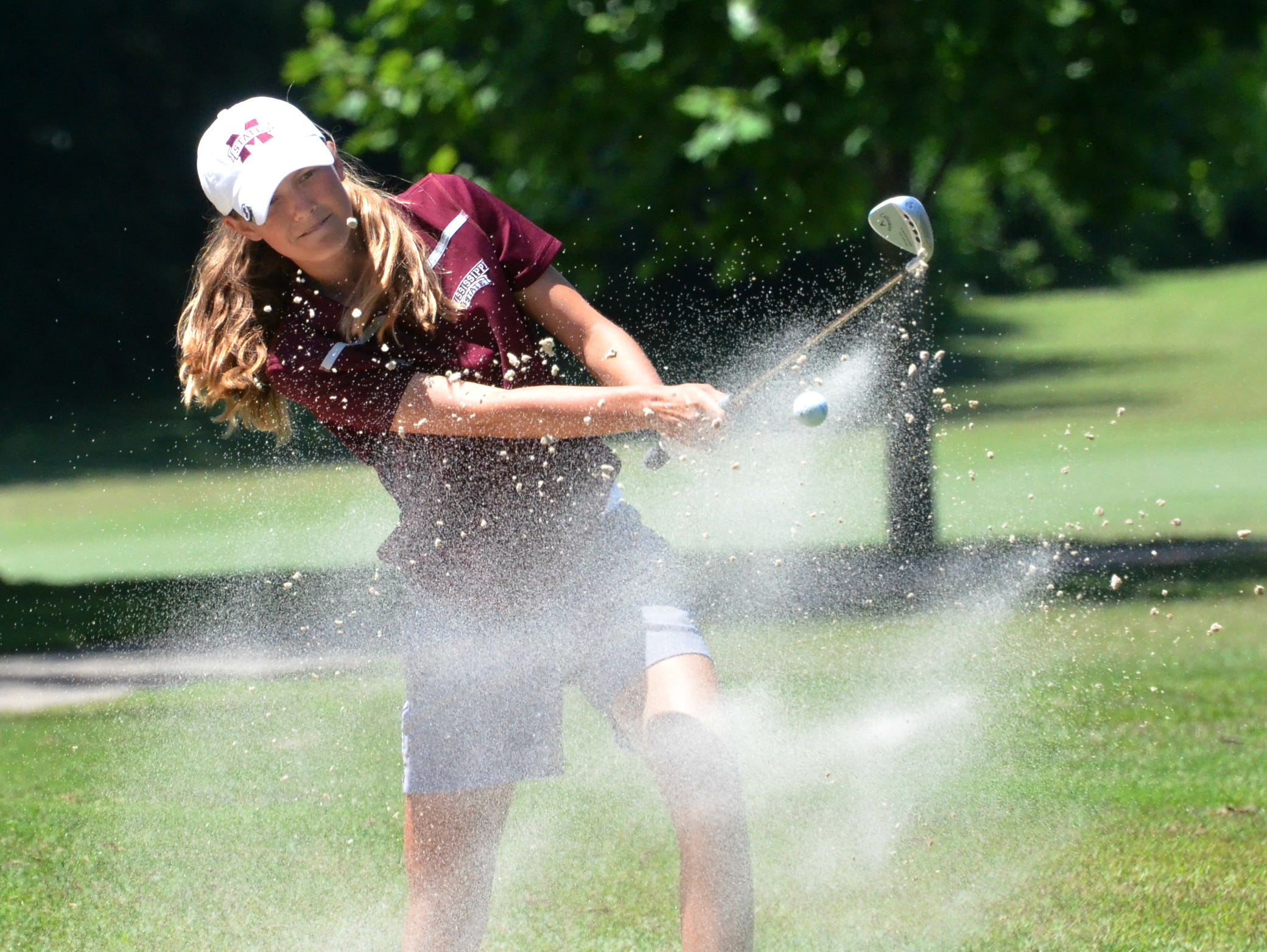 Ashley Gilliam hits out of a bunker during Thursday's championship round of the Schooldays Golf Tournament at McCabe.