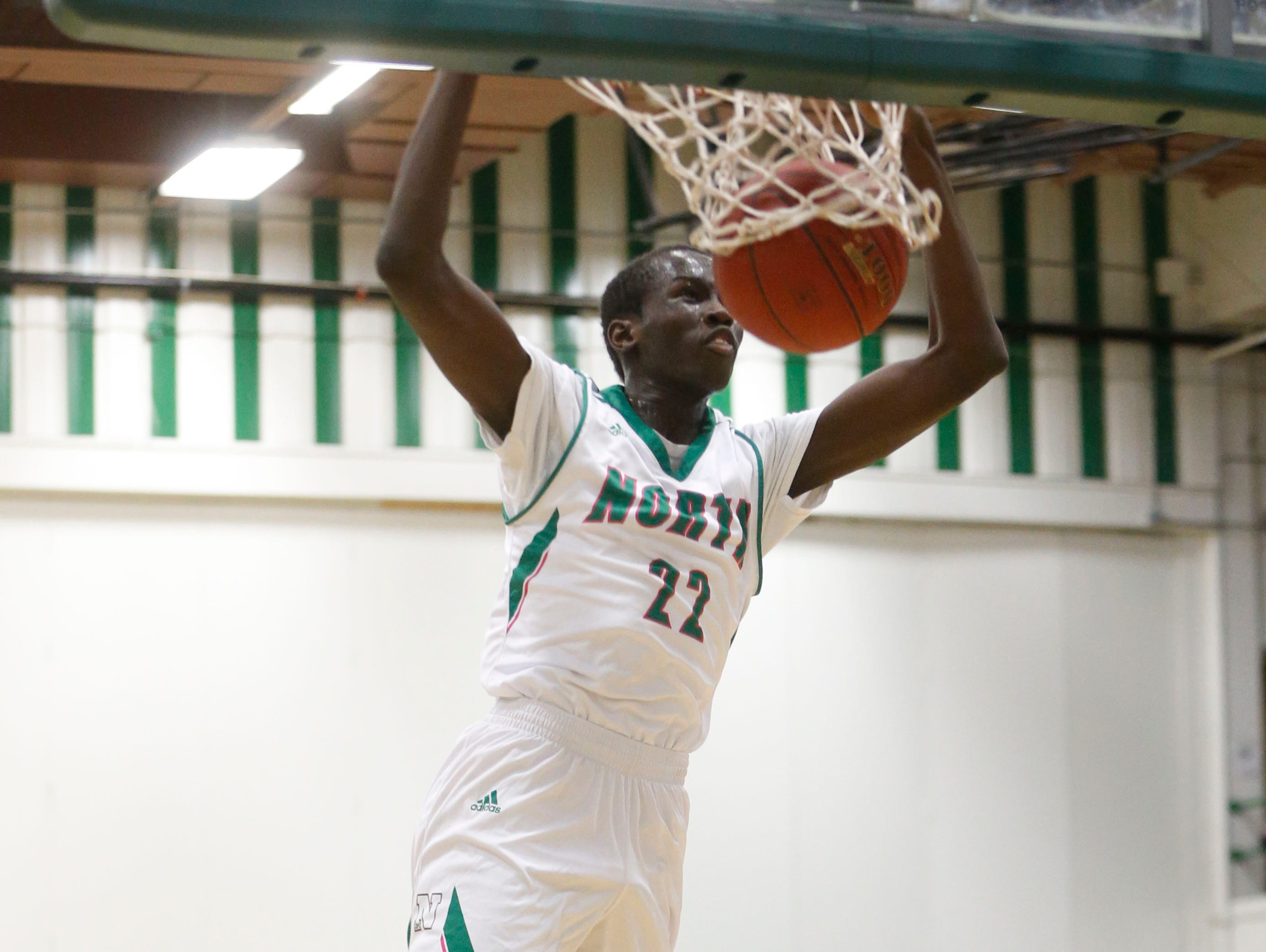 North senior Jal Bijiek (22) dunks the ball against Hoover Friday, Jan. 6, 2017 during their game at North High School in Des Moines