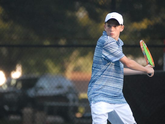 St. Clair's Eli Pinnoo returns a shot during the Division