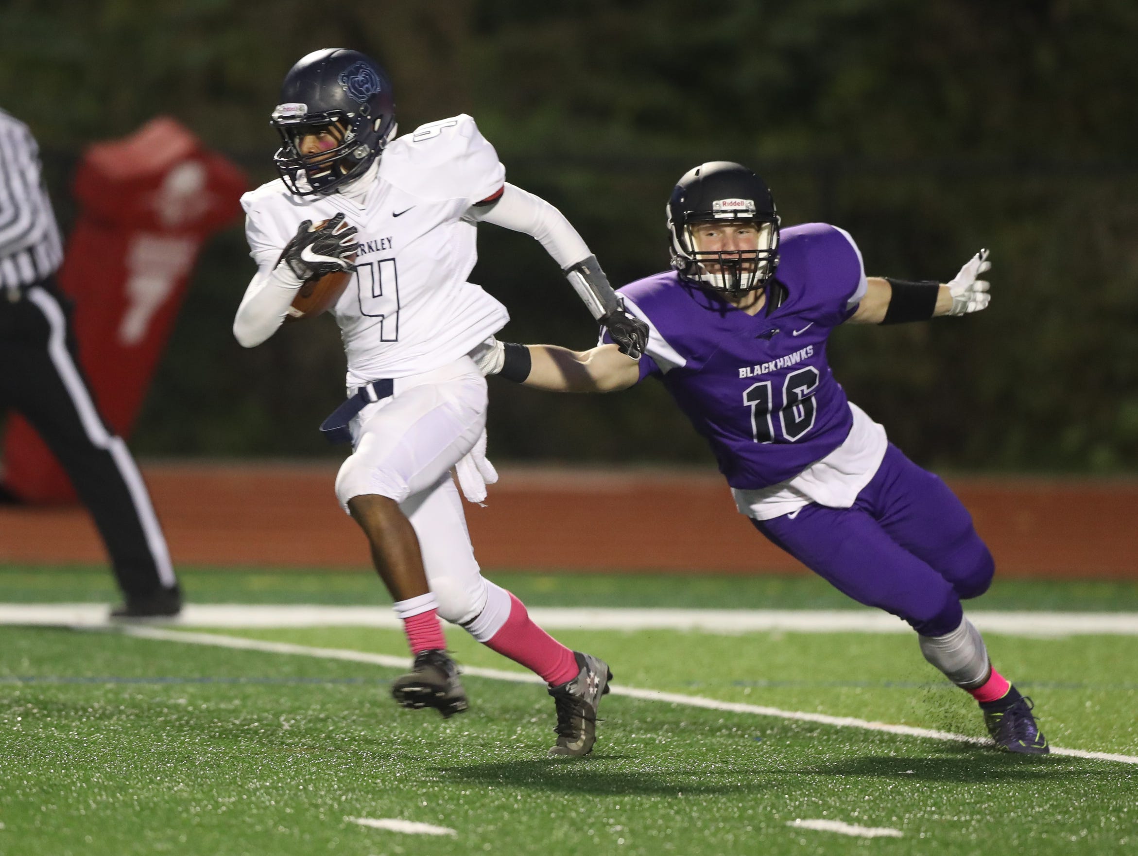 Bloomfield Hills' Marco Lozano tries to tackle a Berkley ballcarrier Friday at Bloomfield Hills.