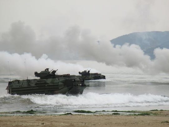 Marines aboard amphibious assault vehicles rehearse