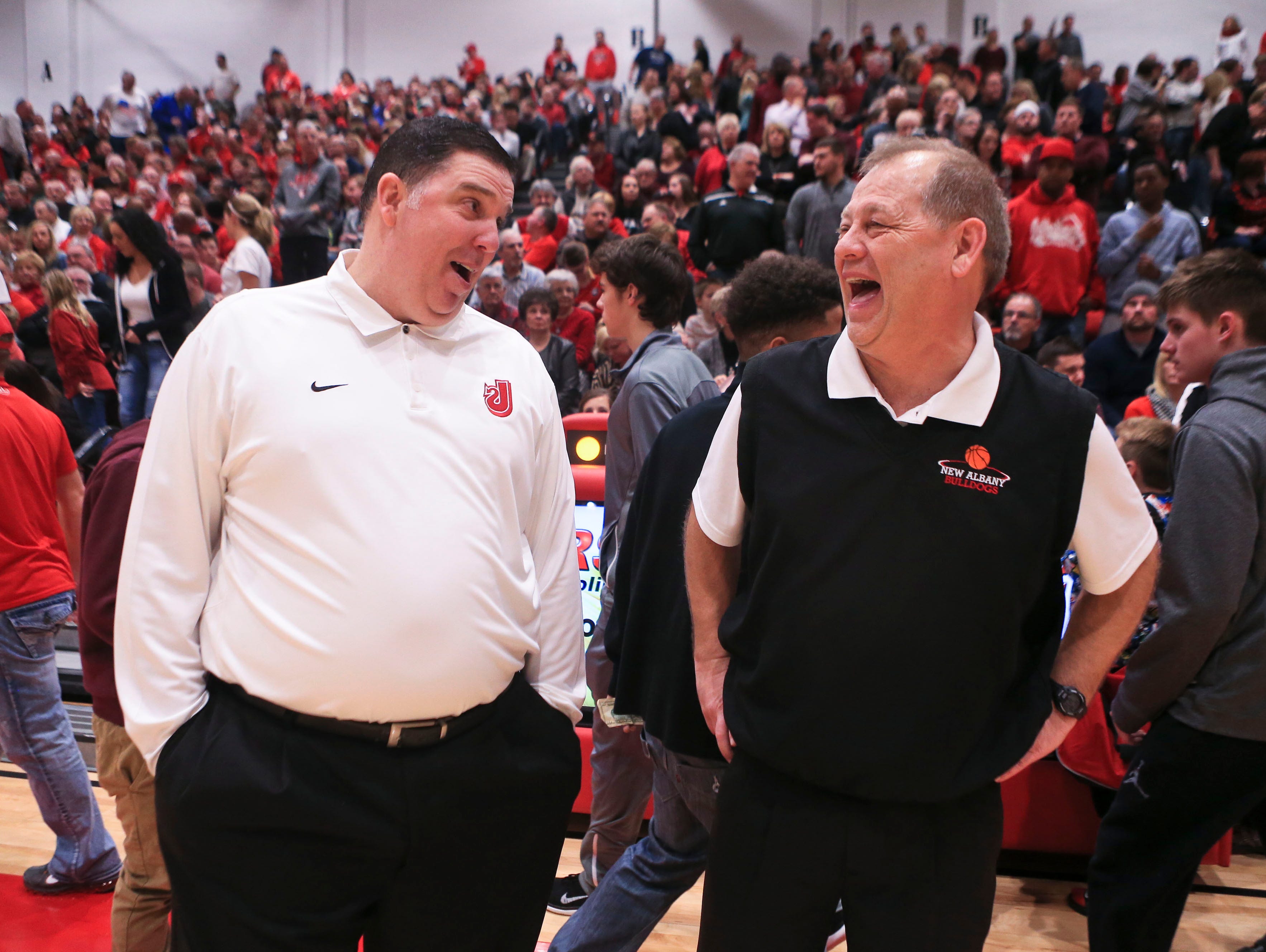 Jeff coach Joe Luce and Jim Shannon talk before the Red Devils-Bulldogs game. It would be the 156th meeting between the two schools.